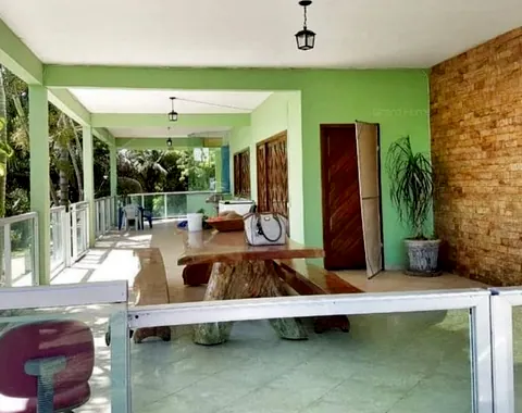 Varanda coberta com mesa rústica de madeira